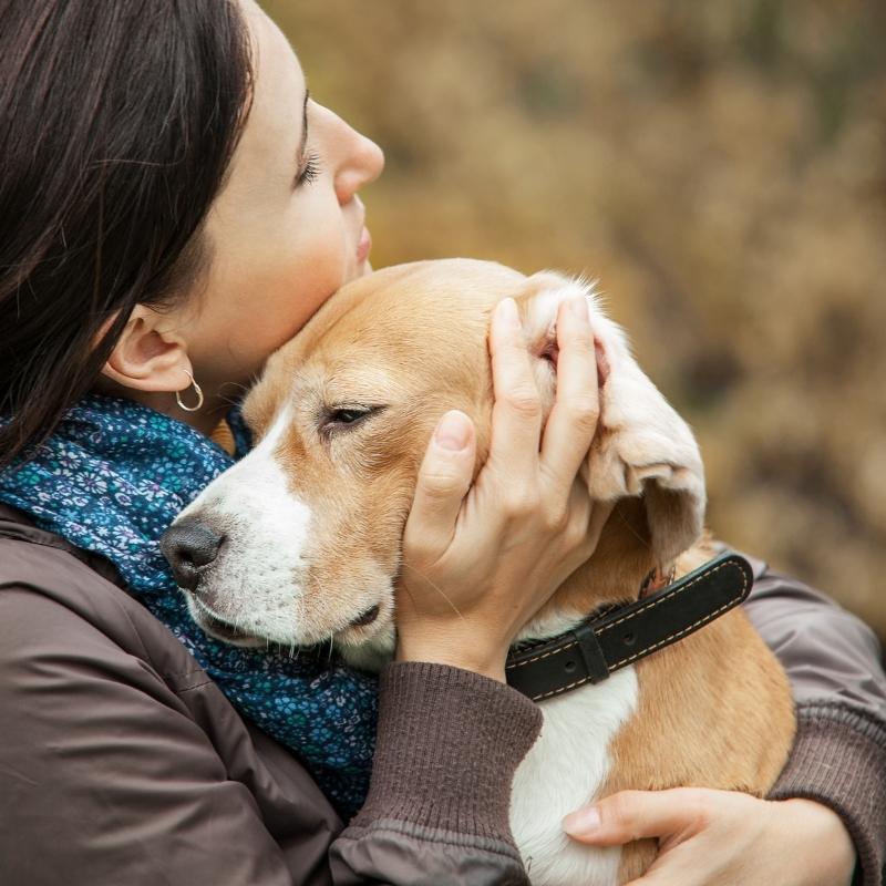 Lady hugging dog showing it love